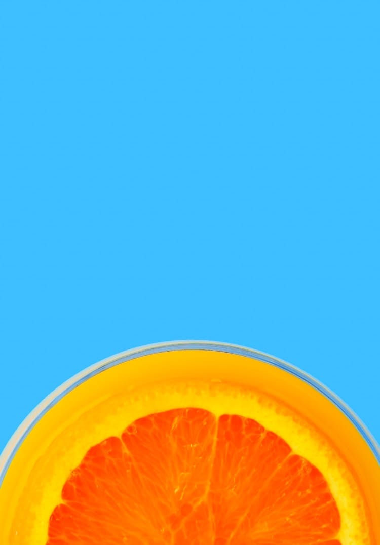 A slice of orange on a blue background